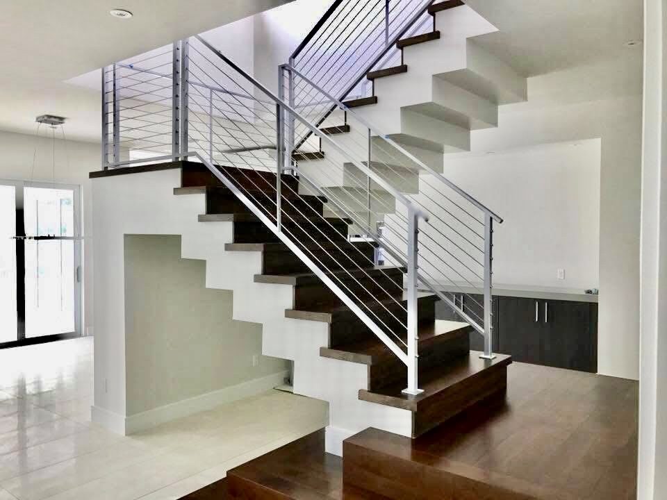Floating staircase with cable railing and wood treads