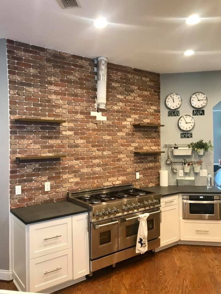 Kitchen with exposed-brick backsplash and pro-grade range